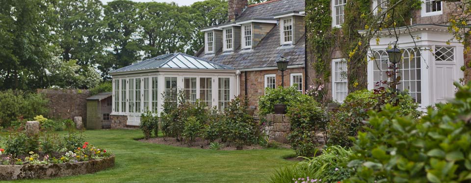Classical double-hipped conservatory with a glazed roof in Jersey